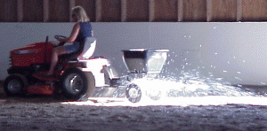 Spreader application of MAG Flakes in horse riding arena